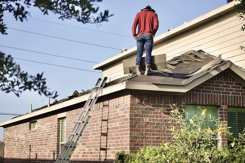Professional roofer working on a residential roof in Valley Place